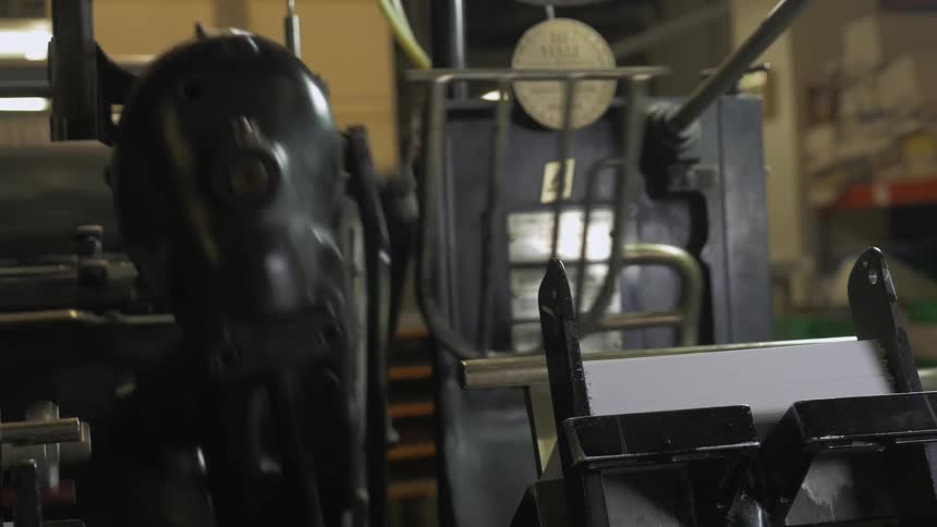 A machine is stacking papers
