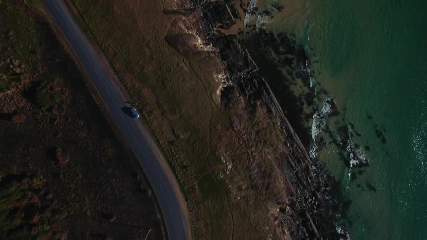 Aerial view of a road next to a beach