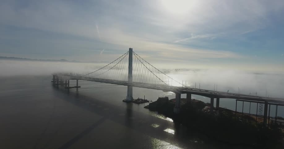 An extended view of a bridge over a large body of water