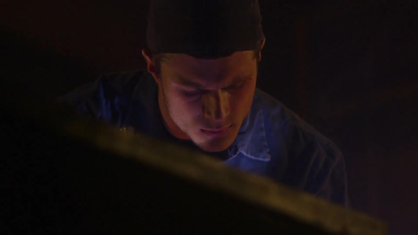 Man sits at a desk looking down