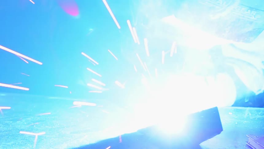 Person welding a piece of metal