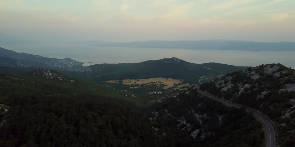 A mountain lake is shown at sunrise