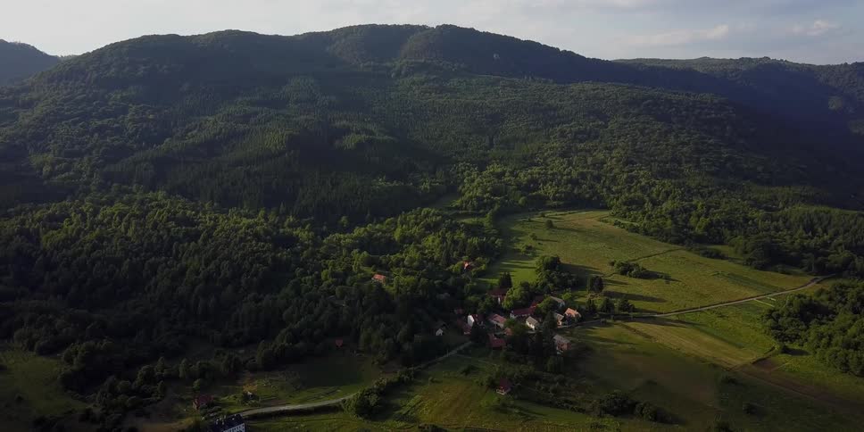 A village sits nestled in a mountain valley