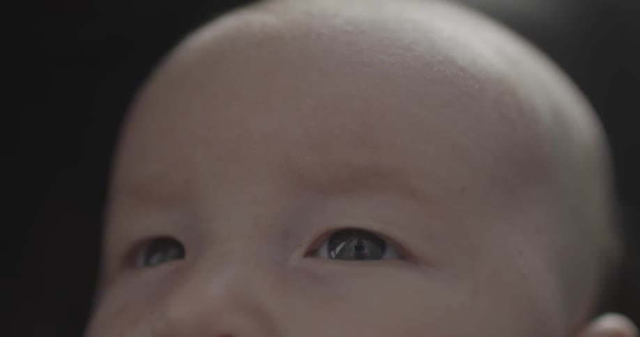 A baby drinks from a bottle