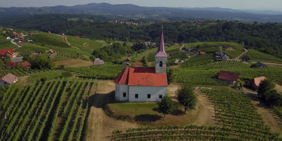Church atop a hill with houses on the hillside