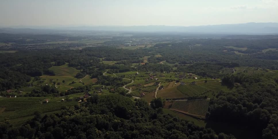 The pastures below are full of hills and trees