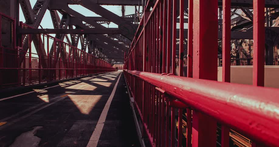 Pedestrians and bicyclists cross a city bridge