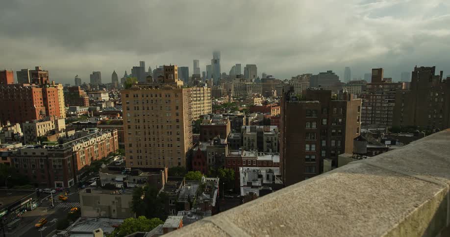 Dark clouds move over a city during the day