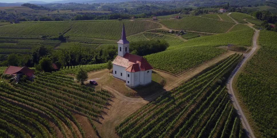 A small church is on a hill below