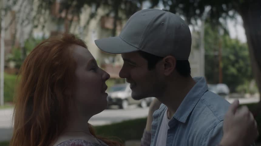 A man chases a woman and they kiss
