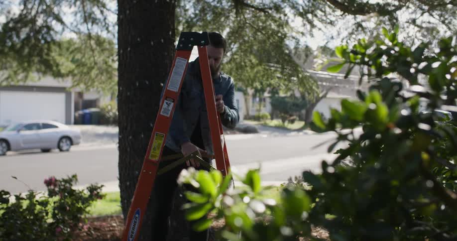 A man opens a ladder