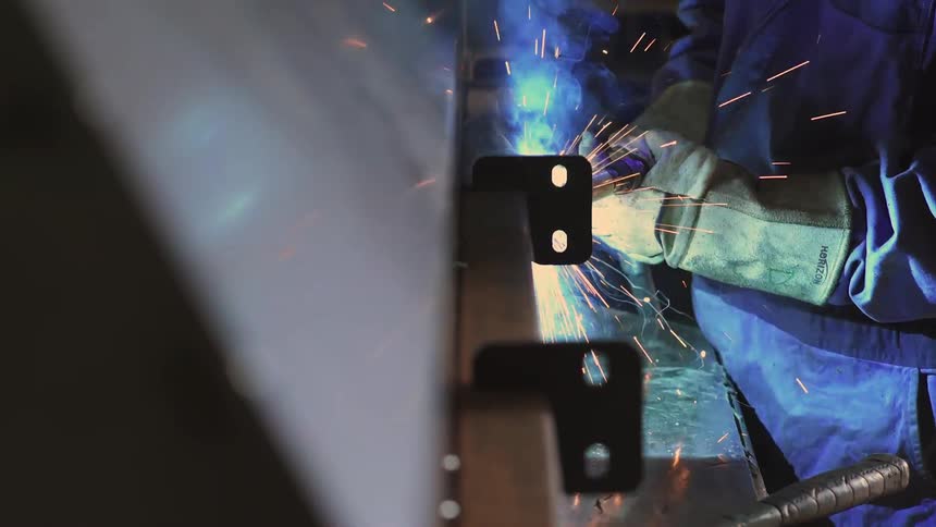 Person welding with sparks flying up