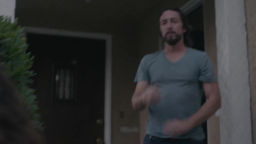 A woman walks away from a man leaving him as he begs her to stay