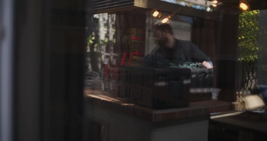 Man working on electronics outside on a patio