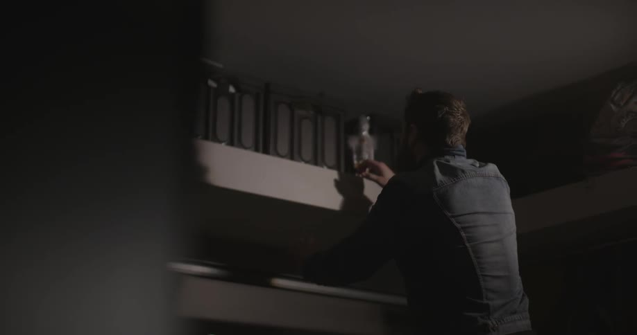 A man removes a crate from a shelf