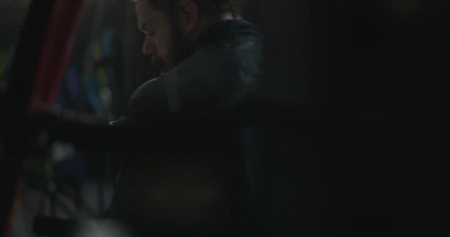 A man moves through a dark room