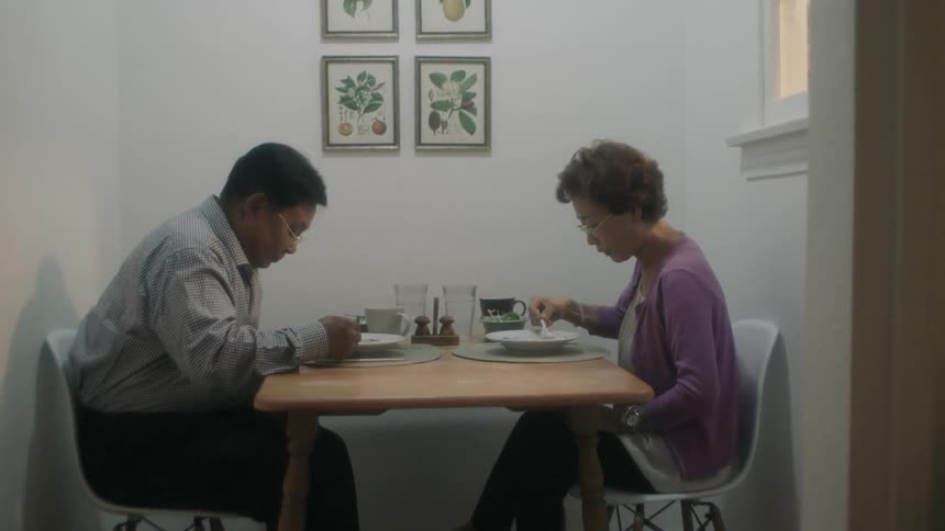 A couple sit down to a meal together