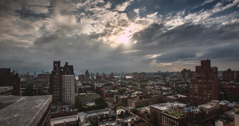 Clouds pass over city buildings