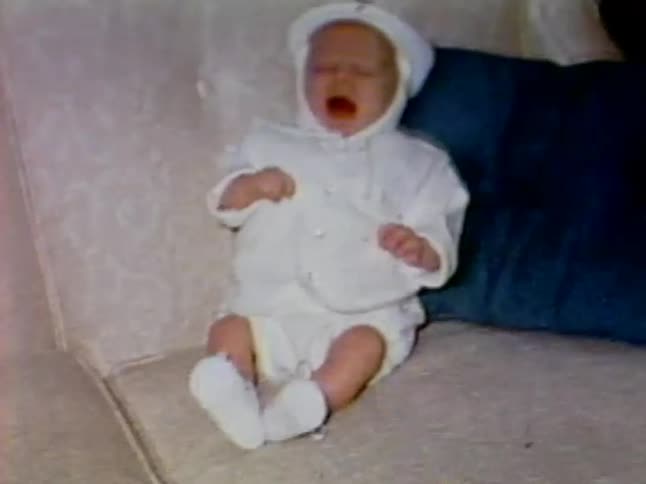 A baby is playing on the couch