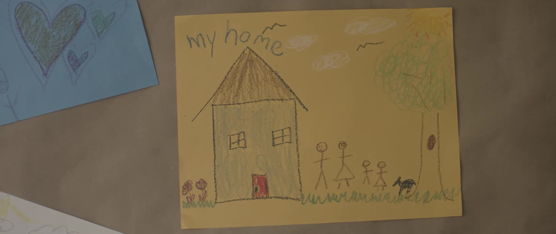 Picture of a house and family on a wall