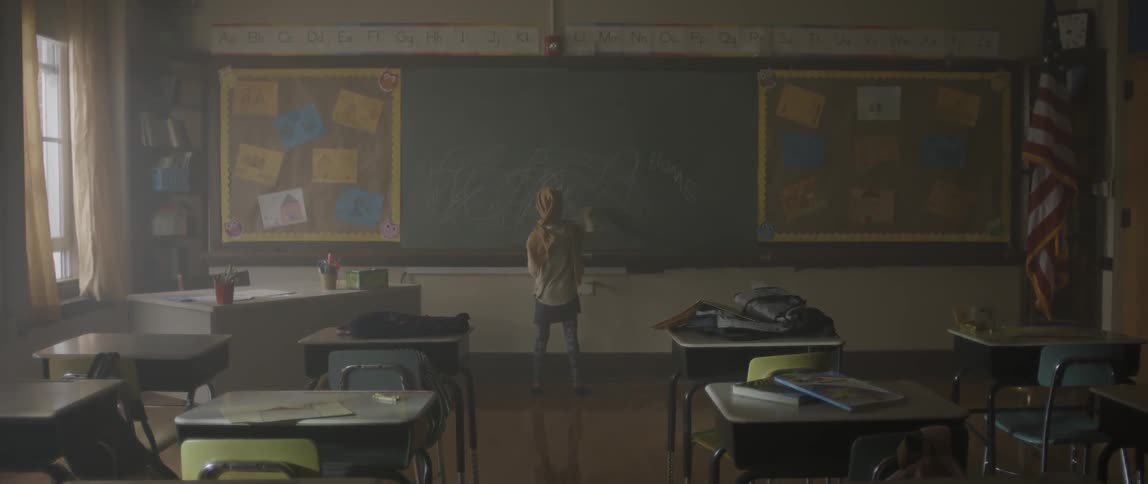 A person is cleaning the chalkboard