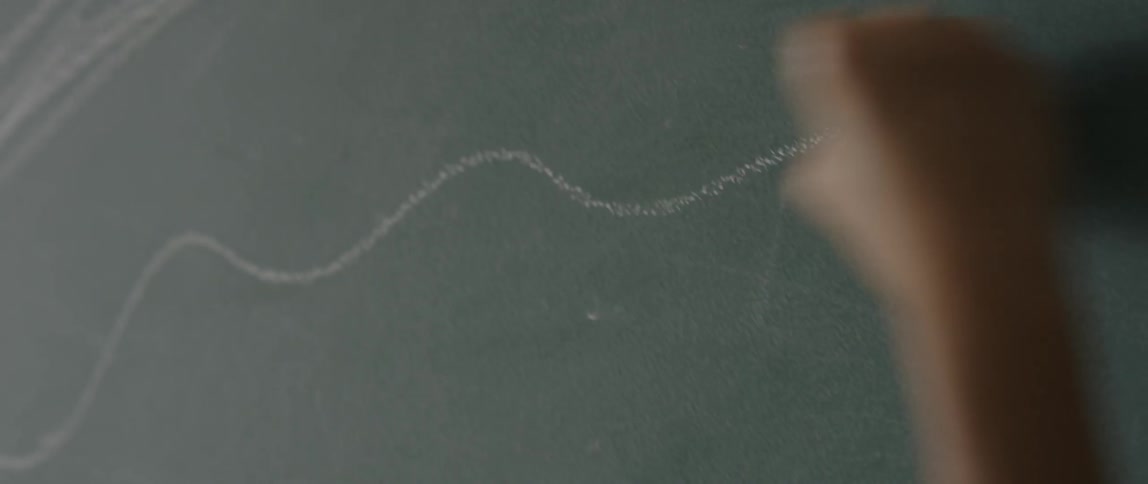 Someone writes a squiggly line with chalk