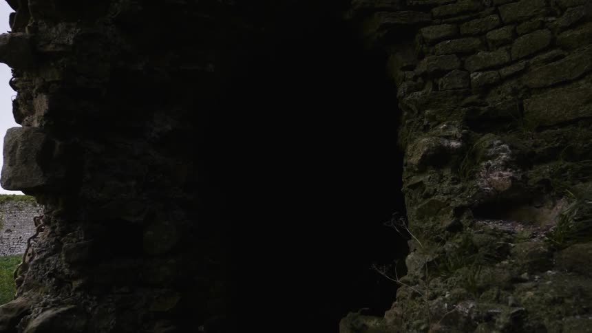 Close up of the side of a large rocky cliff and cave