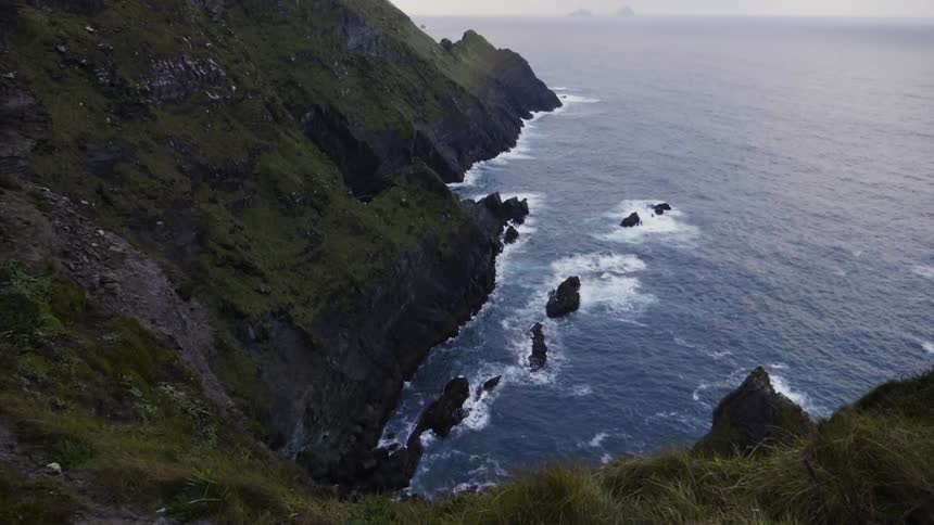 Tall cliffs descend into the ocean below