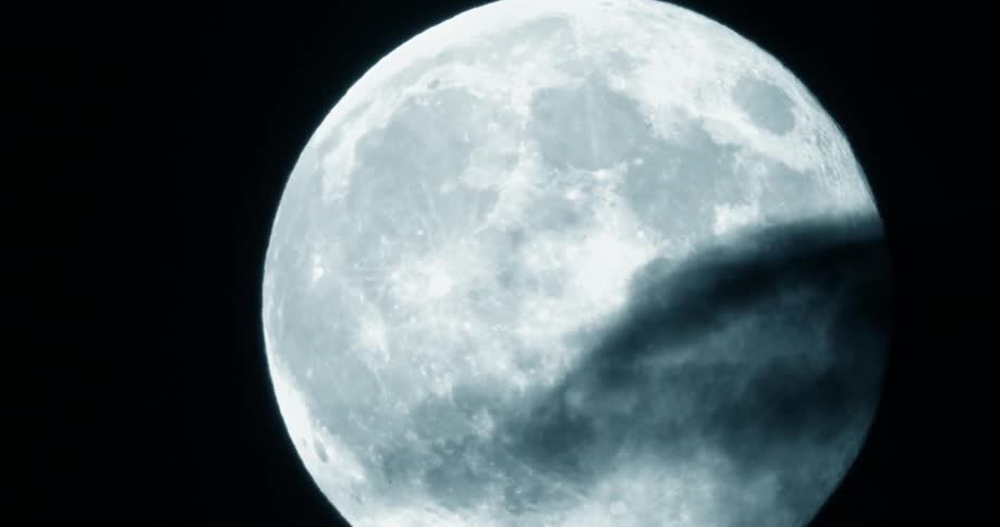 Close up view of the moon on a partly cloudy night