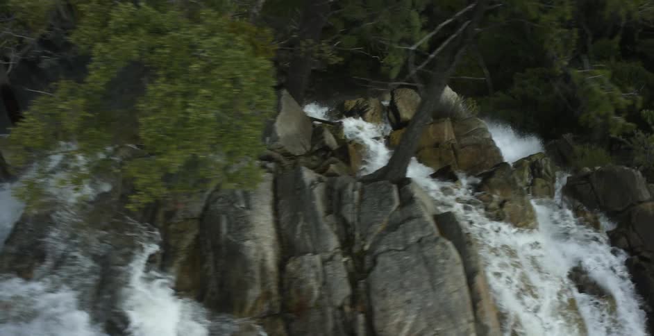 Waterfall splashes into a river