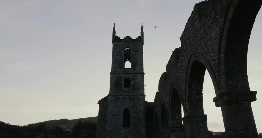 Stone arches and a tall stone building