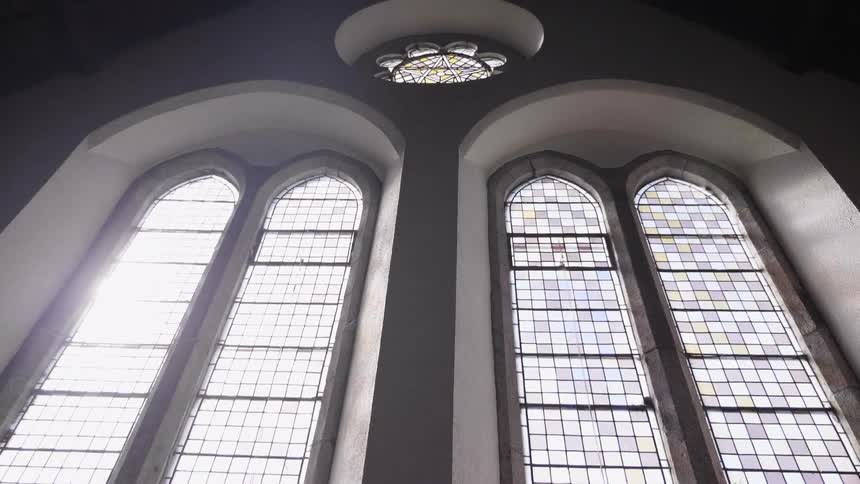 The tall windows are arched and one is a circle