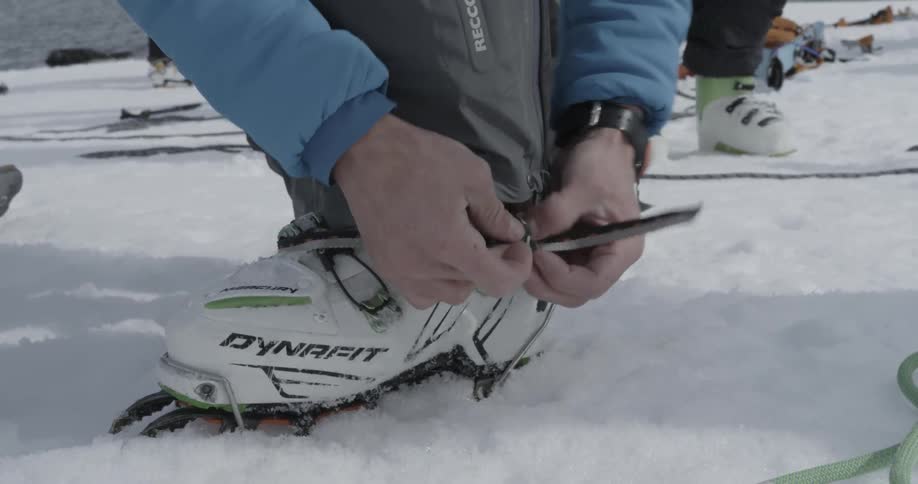 Person tying up their crampons (tight)