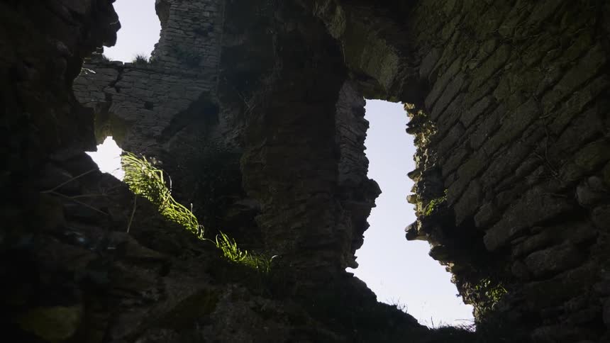 Sunlight streams through an abandoned stone structure