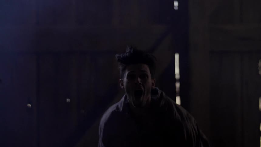 A man running at night tries to stop abruptly