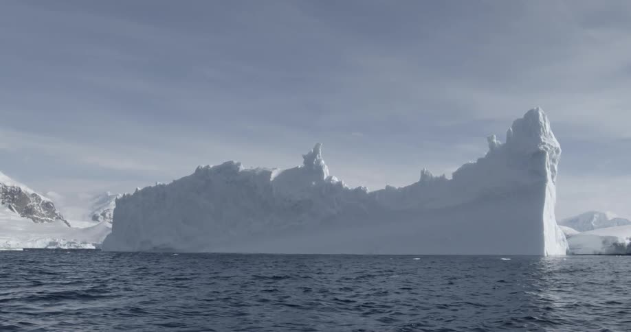 A jagged iceberg floats in the water