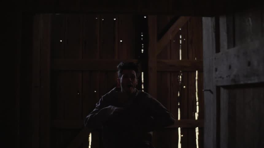 Man running in an abandoned wooden building
