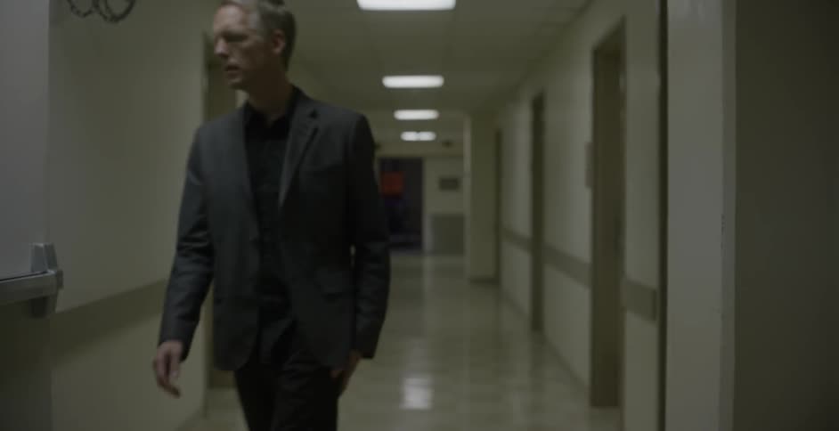 Man walks down an empty hallway