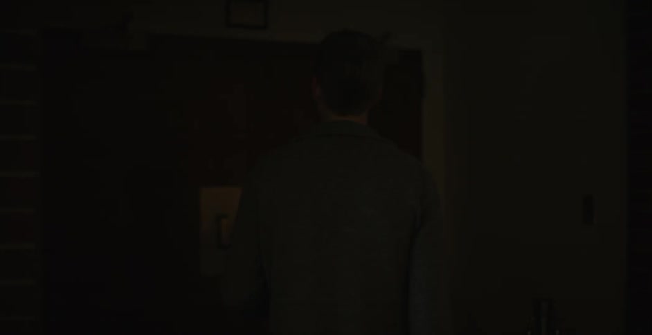 A man enters an empty auditorium