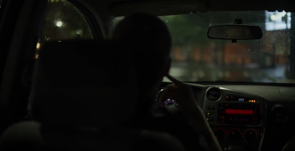 Man driving a car at night