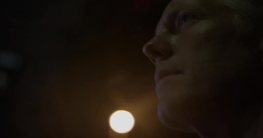 Close up of a man's face in a dim light
