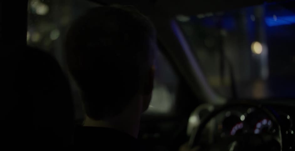 A man drives in the dark