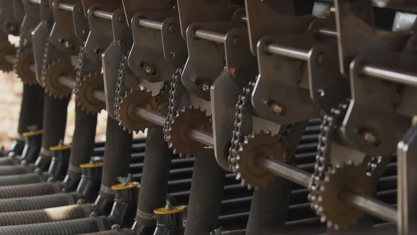Gears and chains are turning on a machine sitting outside