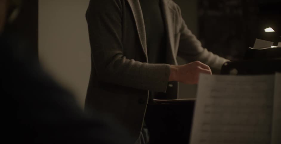 Person flipping through sheet music