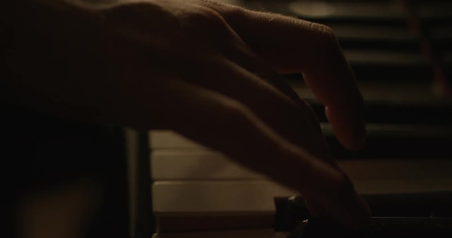 Close up of person playing the piano