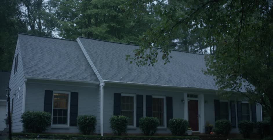A house has large trees around it