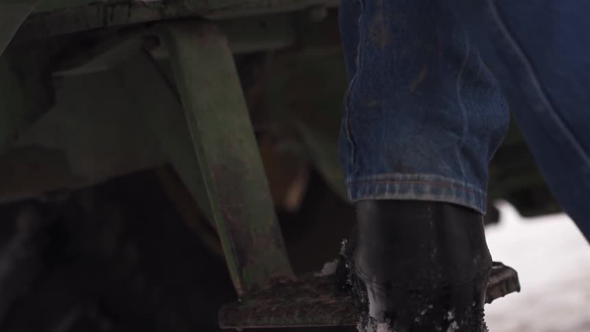 Close up of a person climbing up onto a truck