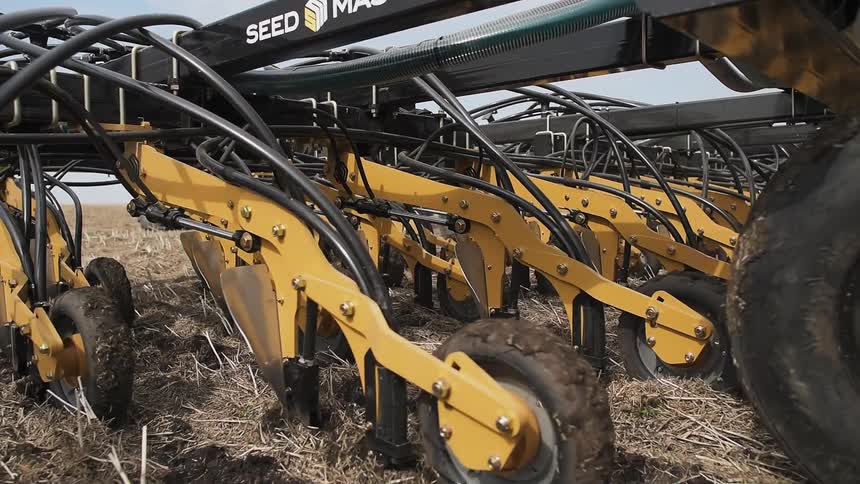 The large farm vehicle is yellow in color