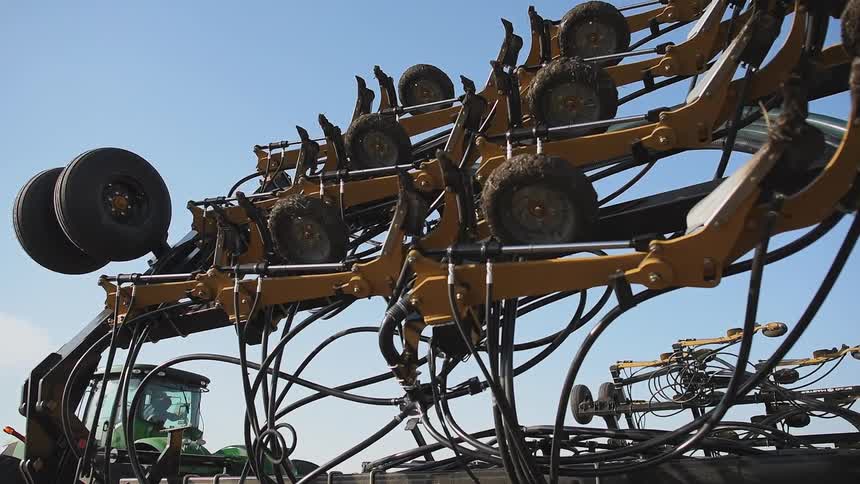 A tractor slowly unfolds