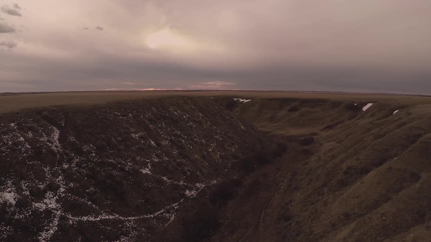 The hills are steep and green at sunset